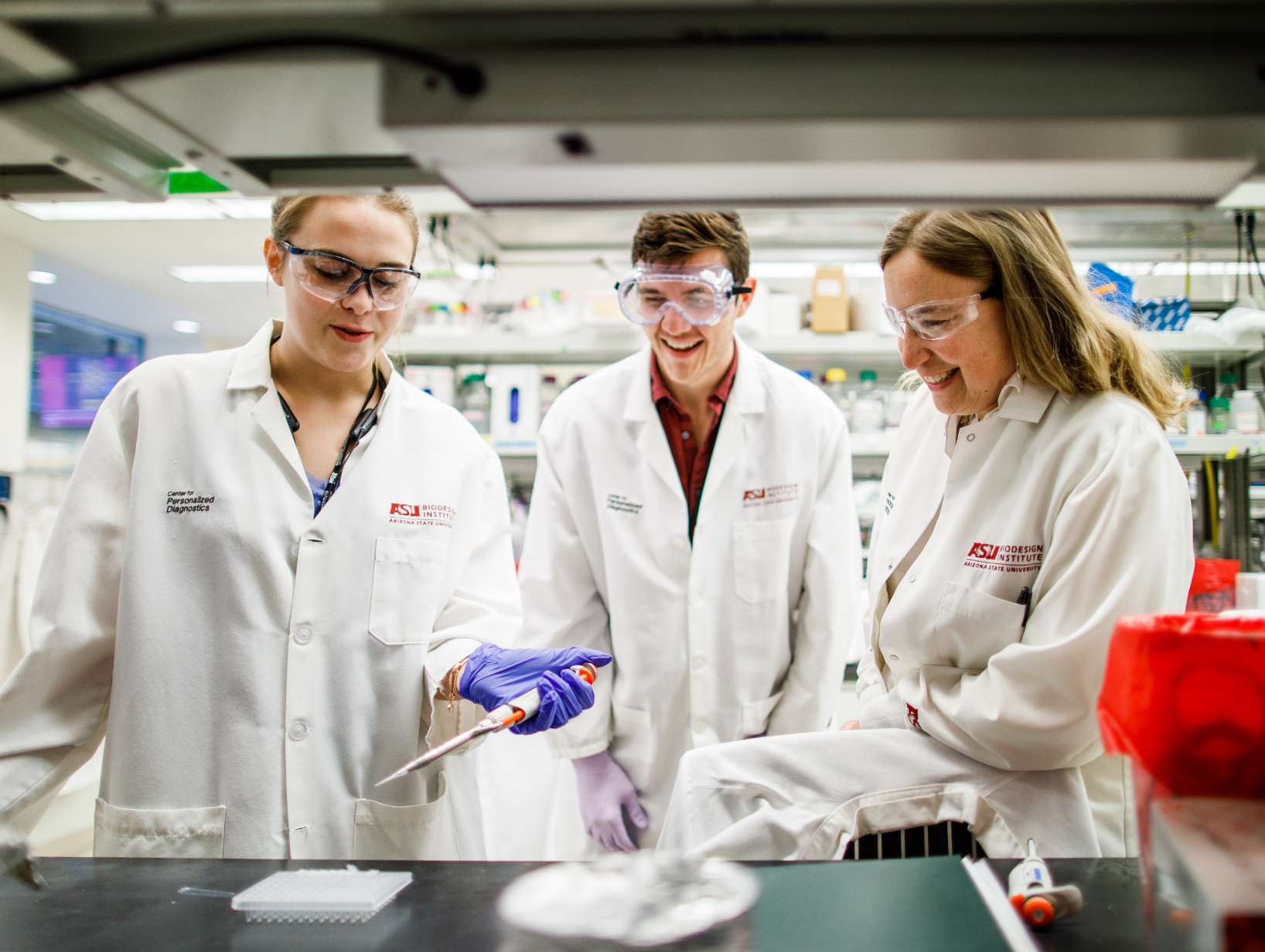 Researchers laugh while working together.